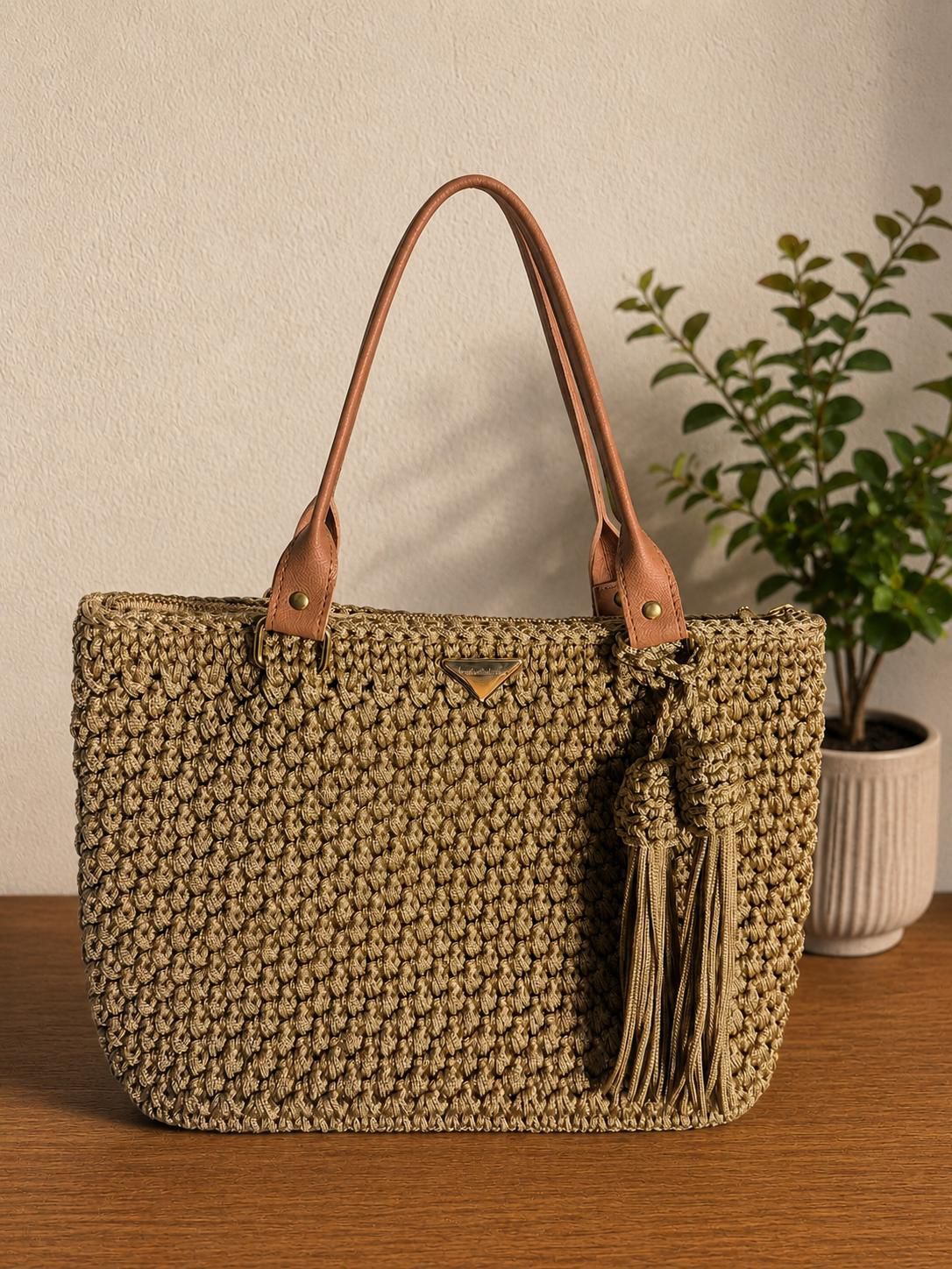Taupe crochet tote bag with tassels, leather base and strap